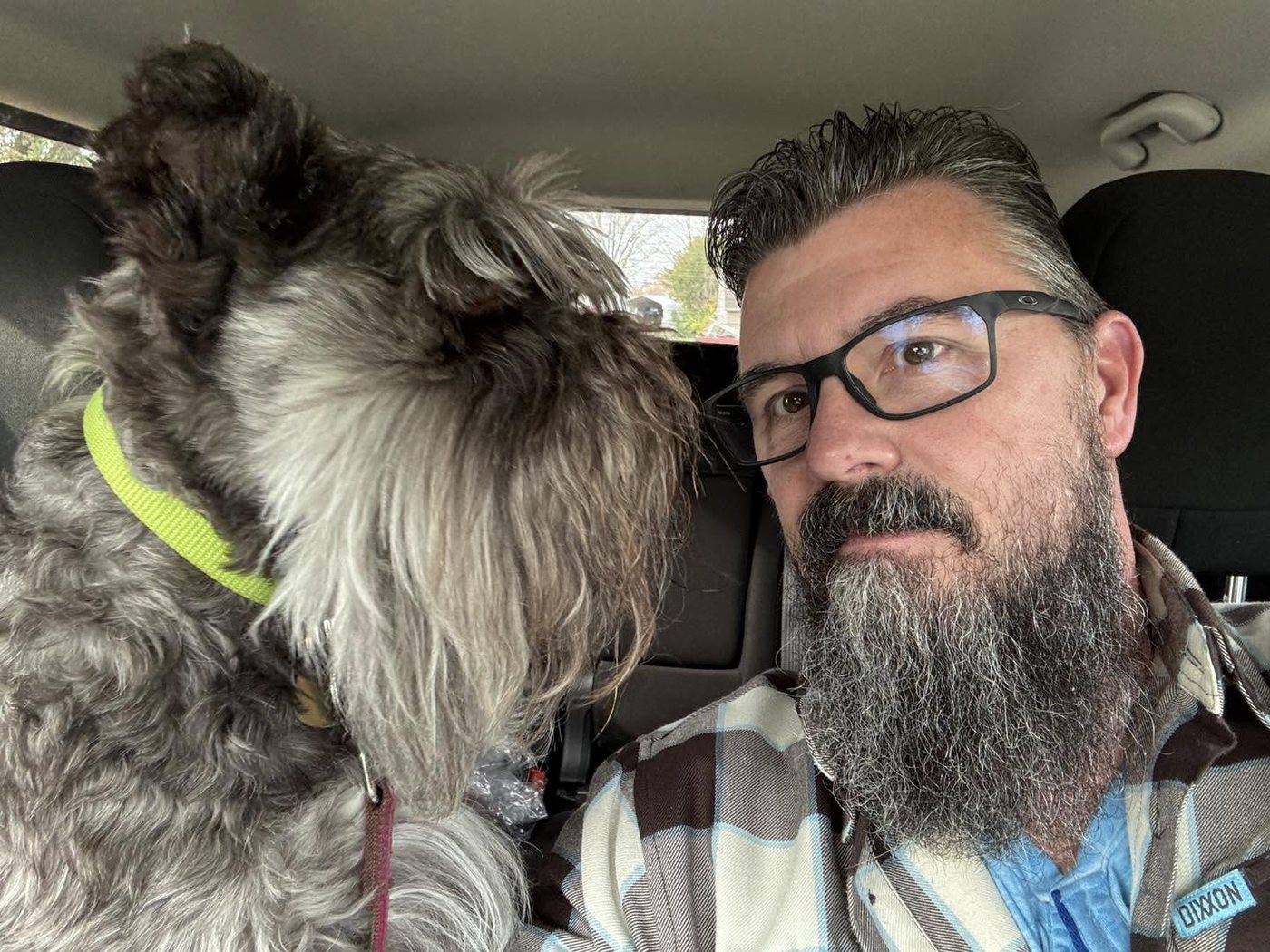 Scot Reedy and Turbo, his miniature schnauzer, in the cab of a truck