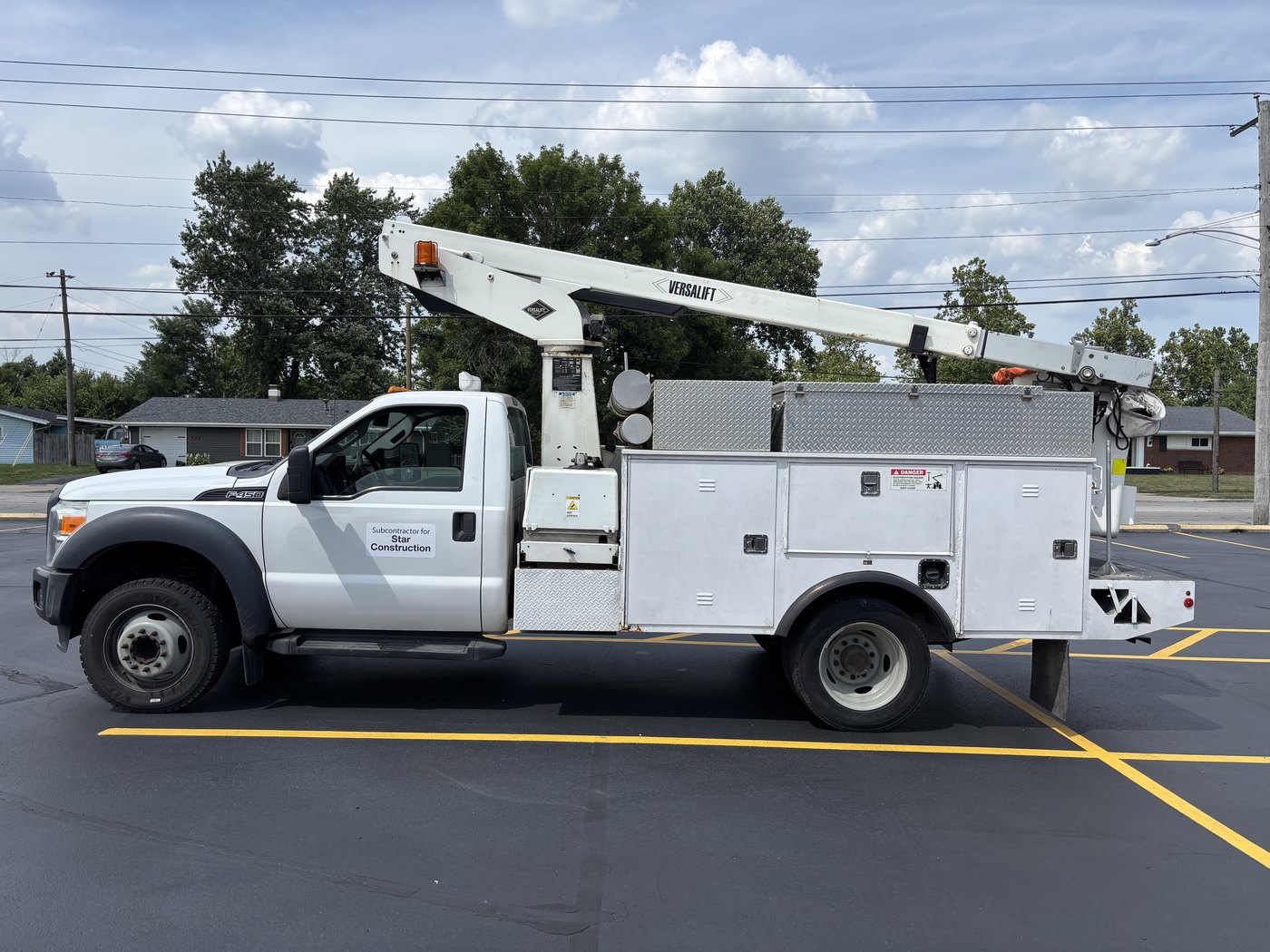 Altura Ford F-450 bucket truck in plain white before wrapping