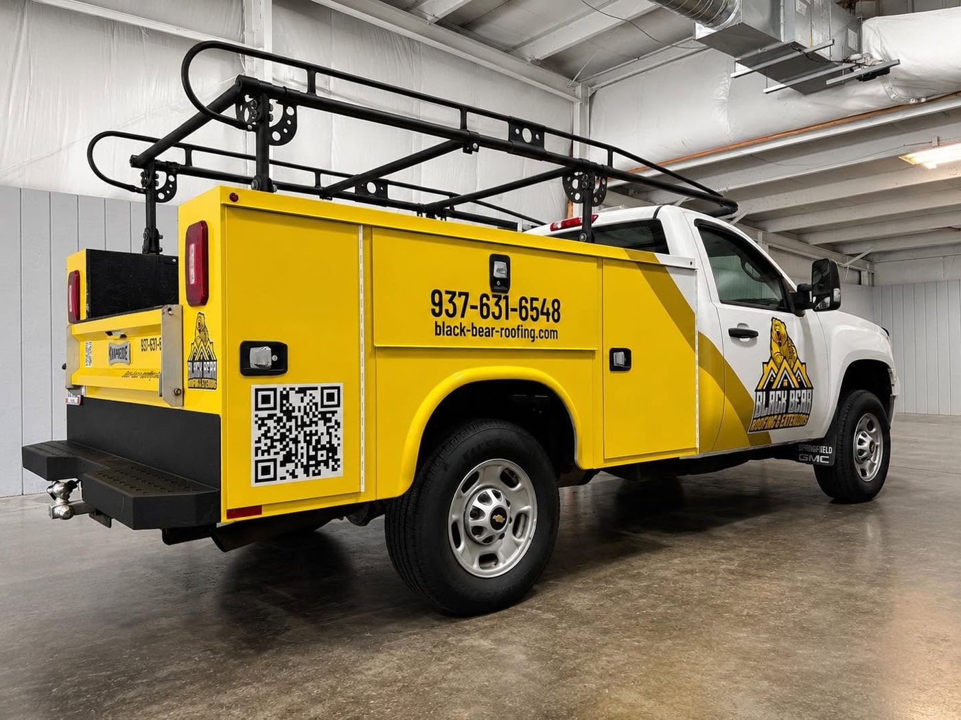 Black Bear Roofing GMC service body truck in yellow and white